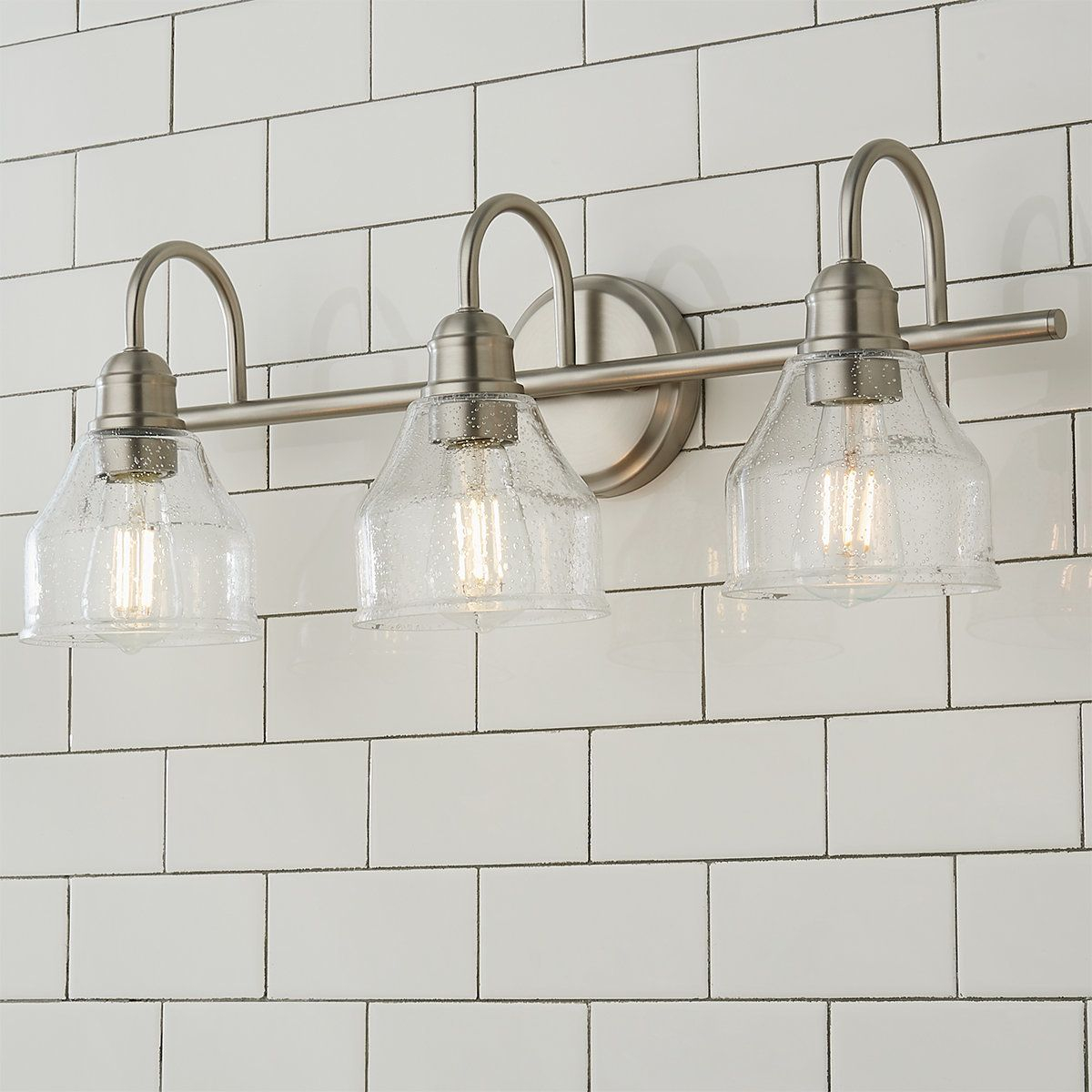 Tapered Seedy Glass Shades Elevate This Bath Light Collection In ... inside Illuminating Your Space A Guide to the Aliana 3-Light Brushed Nickel Vanity