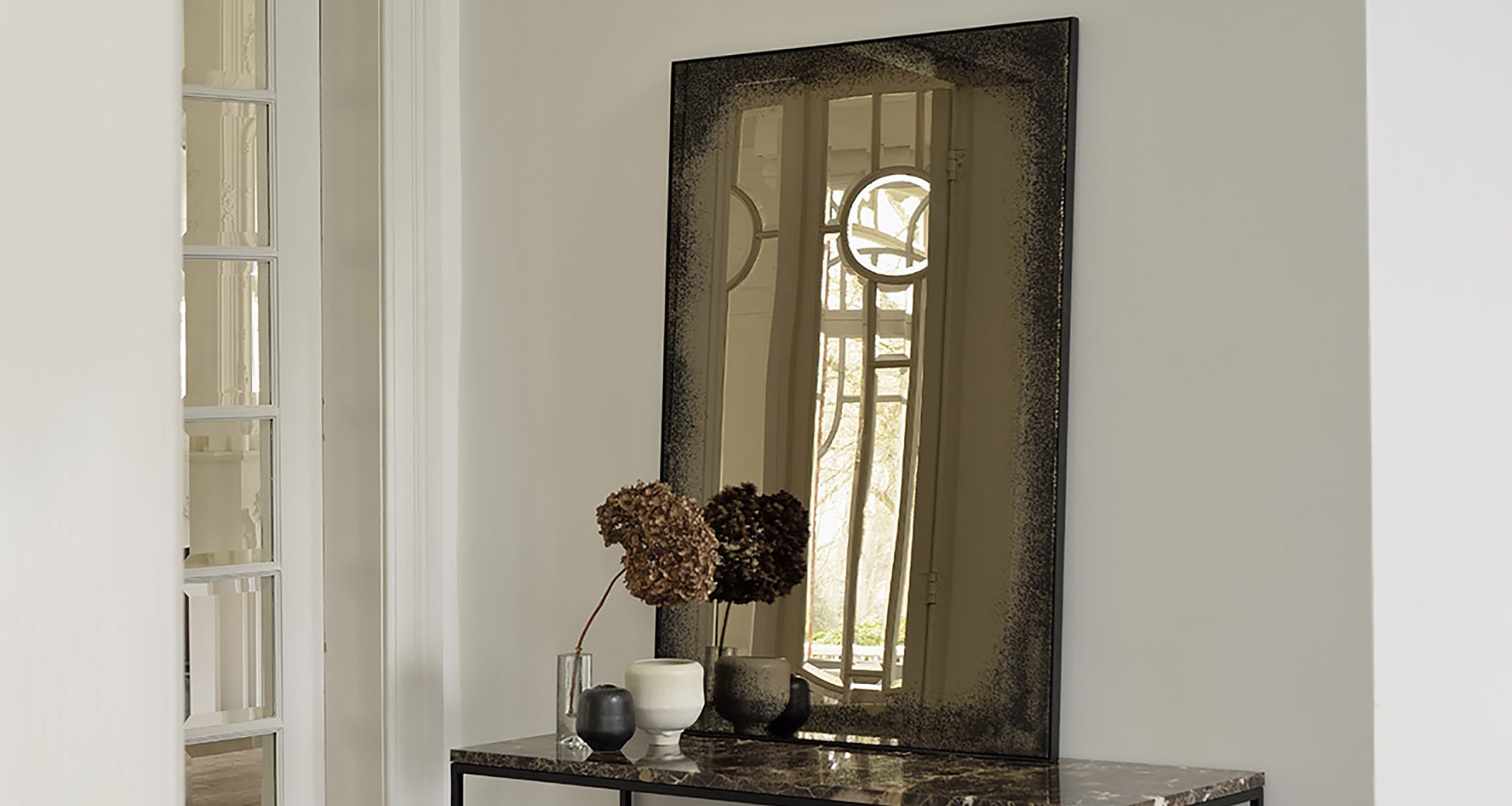 Aged Wall Mirror | Ethnicraft | Rypen for Designing with Intention The Impact of a Rustic Black and Aged Bronze Mirror