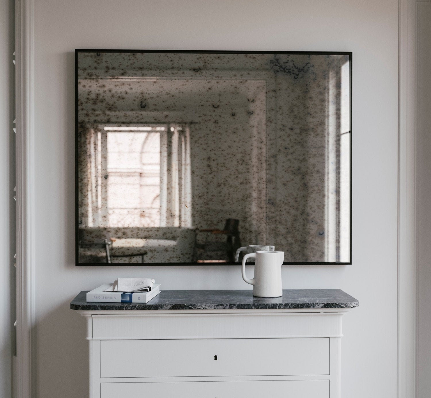Black Wall Mirror regarding Designing with Intention The Impact of a Rustic Black and Aged Bronze Mirror