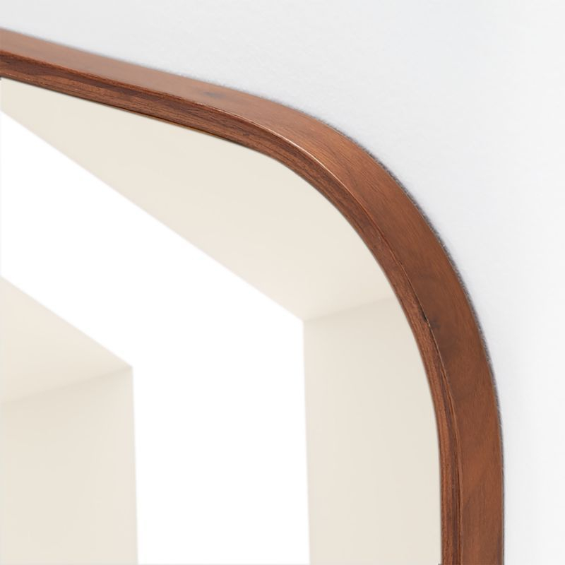 A Wooden Mirror Hanging On The Wall Next To A White Wall With An Open ... throughout The Enduring Charm of Walnut Rectangle Mirrors in Home Design